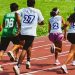 Young athletes compete in a vibrant relay race outdoors, showcasing speed and teamwork.