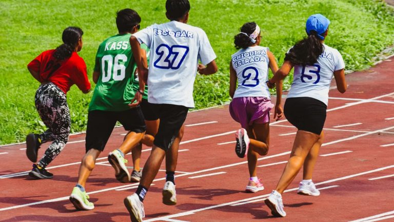 Young athletes compete in a vibrant relay race outdoors, showcasing speed and teamwork.
